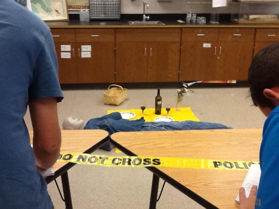 Students taking notes on a mock crime scene during the deadly picnic activity. This activity helps students work on their observation skills as well as connecting evidence to a criminal. 