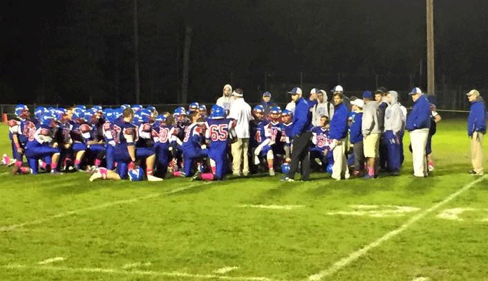 Freshman Evan Cormier joins the varsity huddle during last nights game against Merrimack.  Cormier has been taking snaps with the freshman team but has been suiting up and practicing with the varsity team.  Cormier said he is glad to be given this opportunity [to practice with the varsity team] and to be able to take in the experience.