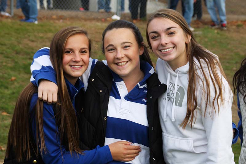 Abby Cowles, Hailey Gilbert, and Jill Murray cheer on the boys.