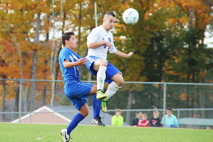 Senior captain Nate Gaw heads a ball kicked by Salems goalie. Gaw also scored the game winning goal in over time.