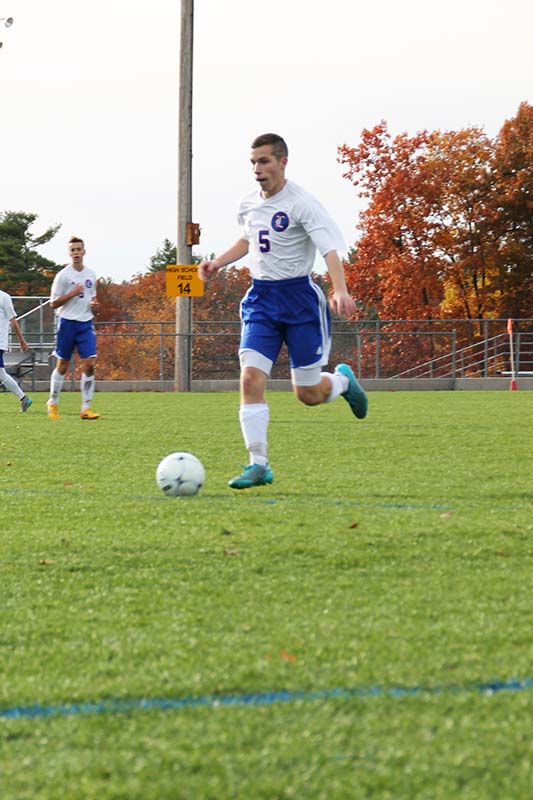 Seniot Scott Lynch brings the ball up the field.