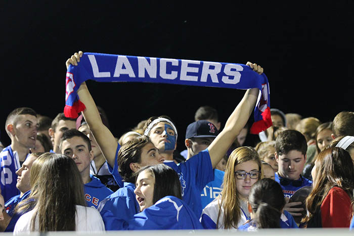 Senior Nick Donnelly cheers on his friends with a soccer scarf.
