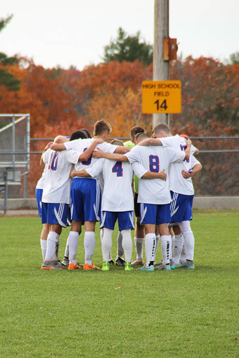 The boys gather in a team huddle during their game against Salem on Saturday Oct. 31.