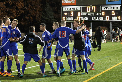 The boys soccer team celebrates after winning the semi-final game. They will head to the championship game on Saturday.