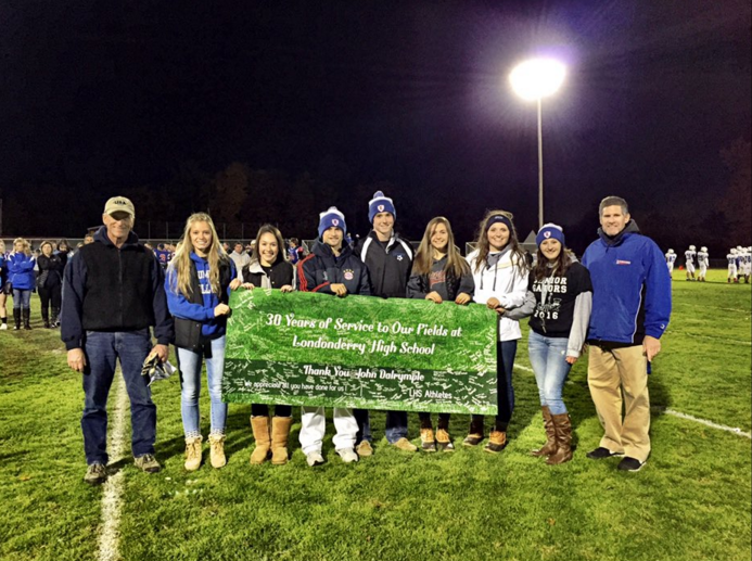 ALC students thanked John Delrymple for his 30 years of hard work and presented him with a banner before he retired on October 30. 