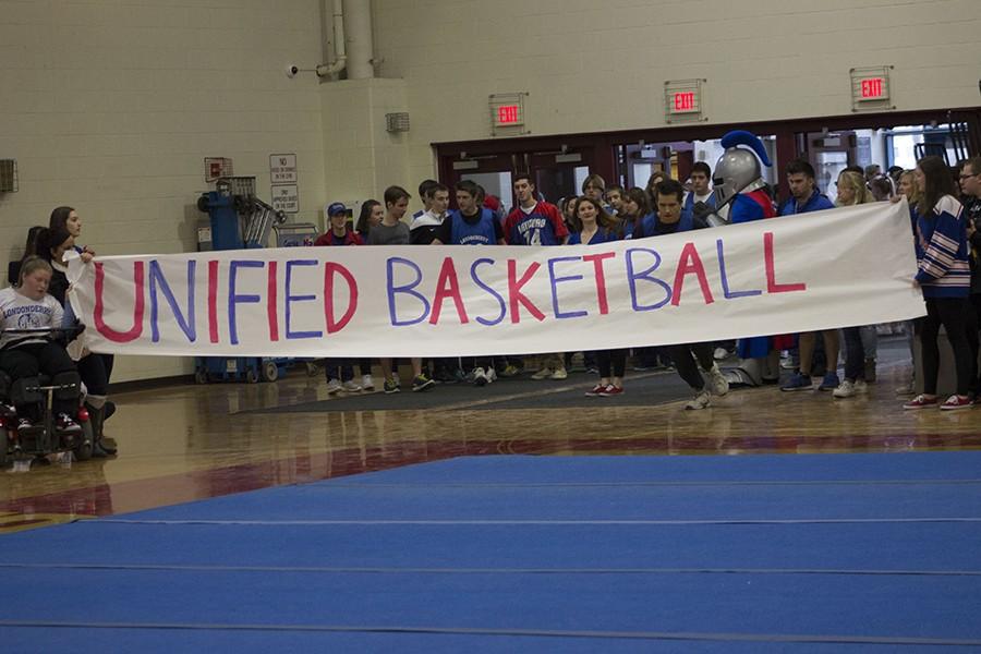 Unified+Basketball+walks+on+to+the+Pep+rally+stage.