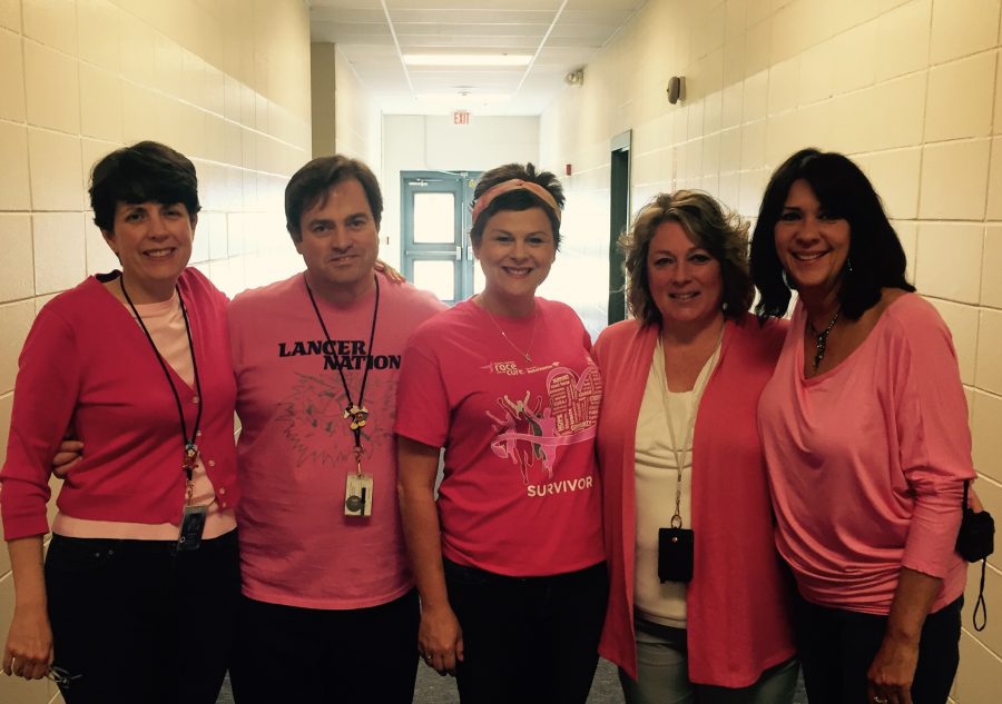 Mr. and Mrs. Juster, Mrs. Young, Ms. Sullivan and Ms. Black dress in pink today to get the word about Mrs. Youngs fundraising efforts.  Young will be participating in the Avon 29 walk this summer and is raising money for breast cancer research.