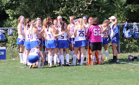 The field hockey team prepares mentally before the game in the huddle. The team will need to bring the same intensity as they did in the Mack Plaque game, according to Shay. 