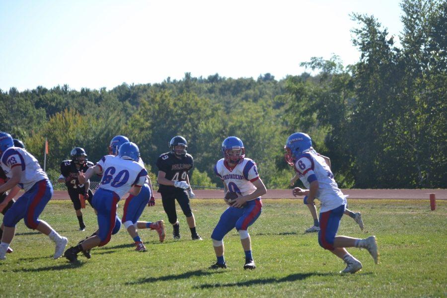 Quarterback Jake McEachern hands the ball of to running back Jeff Wiedenfeld during their 50-14 win against Bedford. 