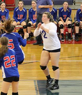 Junior Ashley Andrews passes the ball forward during the Mack Plaque game.  