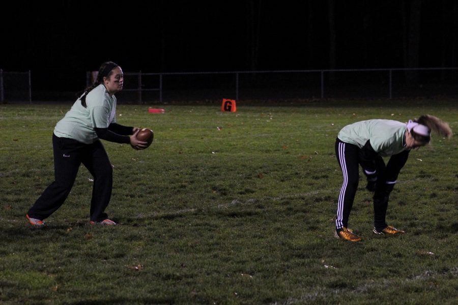 Junior Sarah Fawcett takes the snap at the quarterback position. 