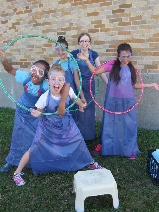 Erin McKenny (back row), works with some of her students from the Curiosity Science Program she created for her Girl Scout Gold Award project.    