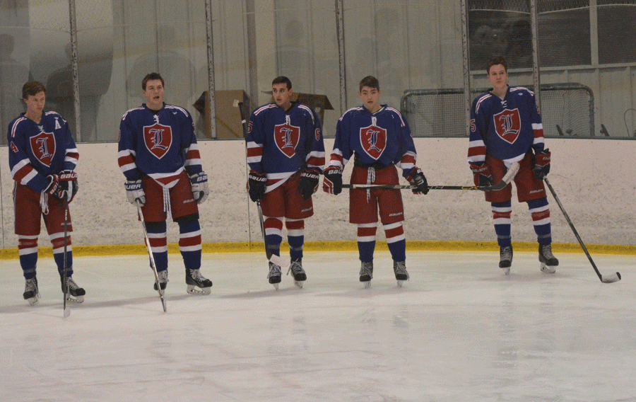 Federico (center) and Murphy (second from right) await their game against their rival, Pinkerton Academy.