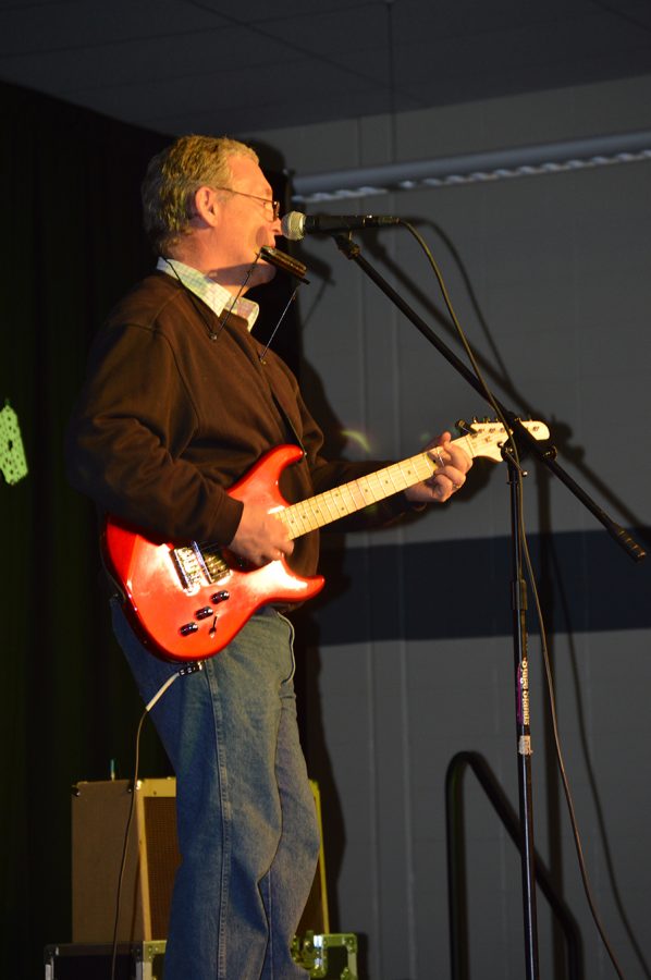 Mr. Prince singing and playing guitar and harmonica to a 1960s  hits medley.