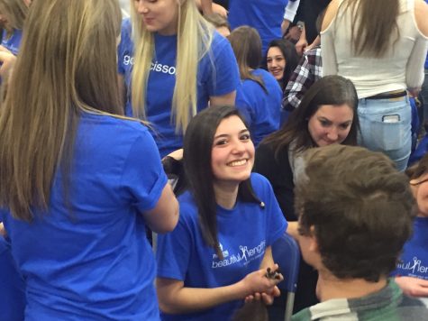 Junior Sophia Saccia holds the ponytails of the hair she donated for Pantene Beautiful Lengths.