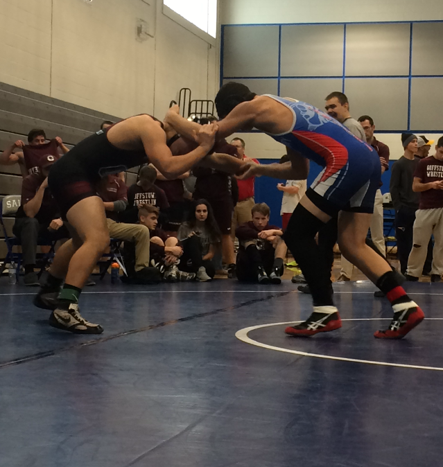 Del Signore (blue) gets the advantage over the Goffstown wrestler.