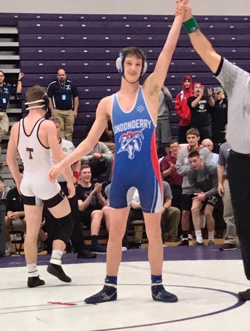 Chase has his hand raised in victory at the Meet of Champions after his defeat of Brandon Berube of Timberlane. 