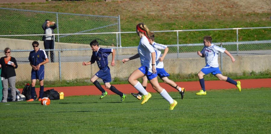 Unified soccer helpers and athletes try to steal the ball from a ConVal player at the October 13 senior night game.  