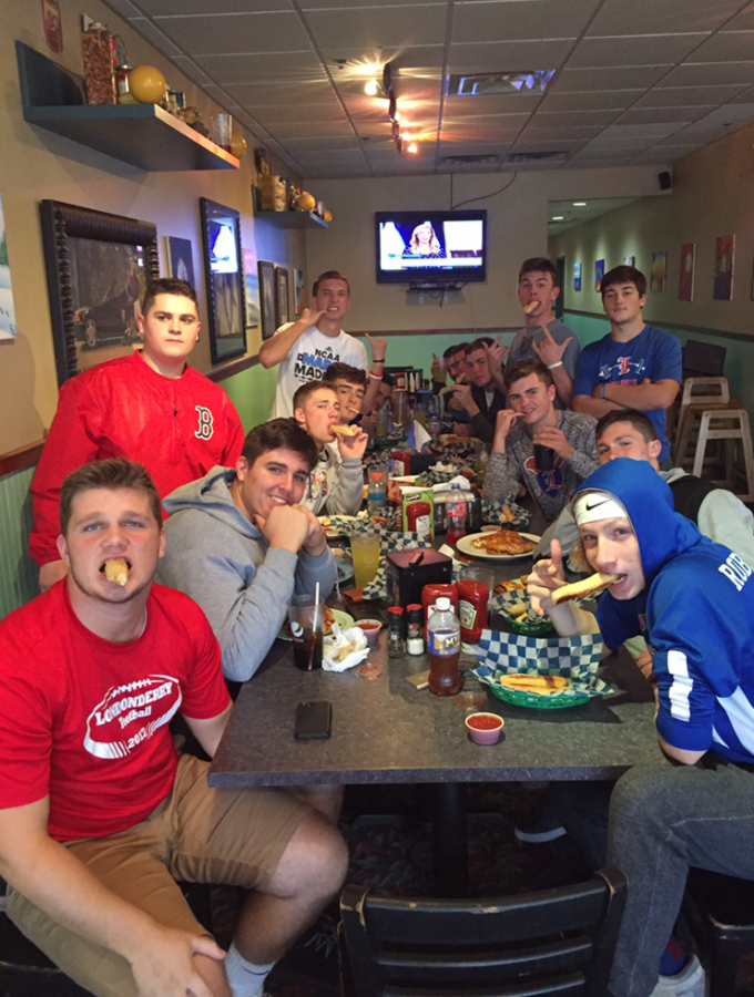 Players from the varsity football team flexing at Juliano’s the Thursday before they they take on the undefeated Salem Blue Devils at home for their senior night. The players are showing their love for the free breadsticks they got with their meals. 
