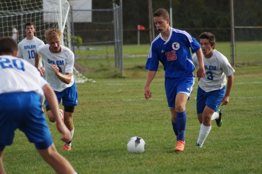 Cava prepares for a kick as he runs by a Salem opponent during his junior year. 