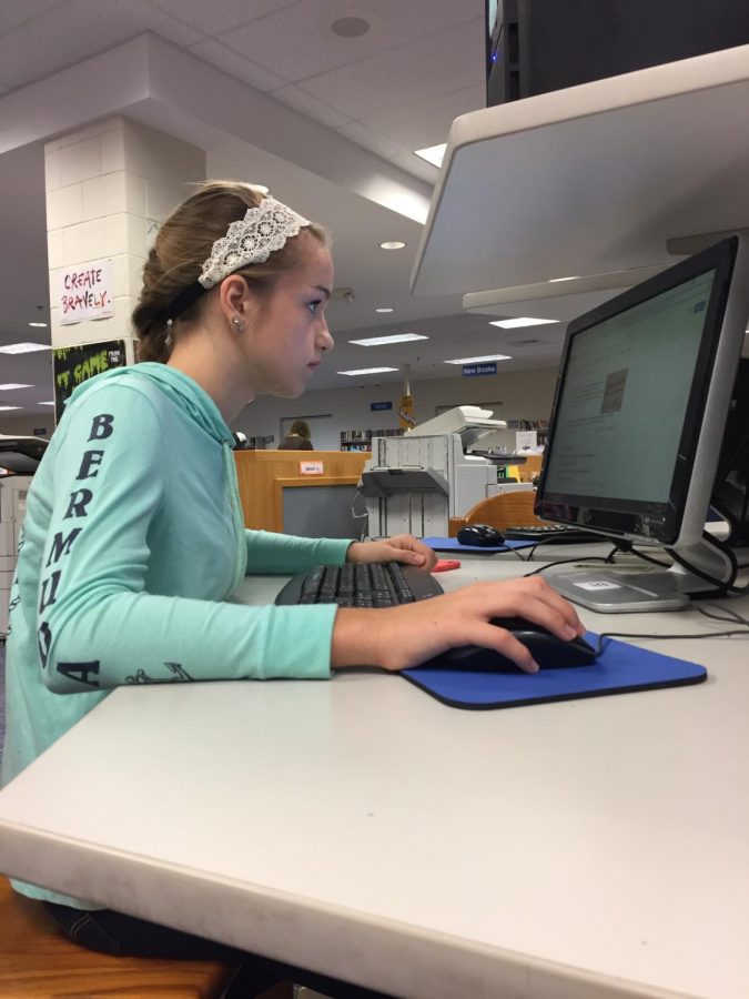 Freshman Gabrielle Page uses one of the library’s computers to research information for her Renaissance project. The library has several computers that are available for students to use during all periods of the day.