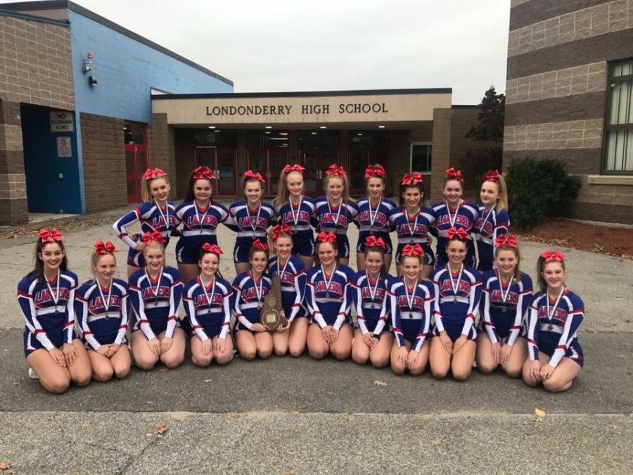 The varsity girls cheer team poses after a victory at states.