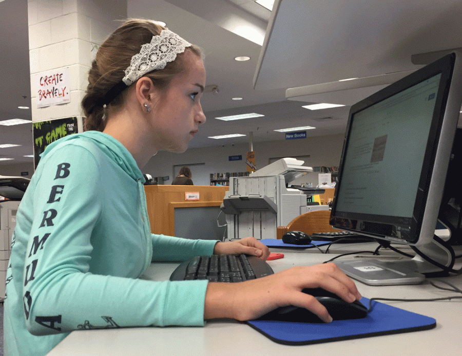 Freshman Gabrielle Page uses one of the library’s computers to research information for her Renaissance project. The library has several computers that are available for students to use during all periods of the day.
