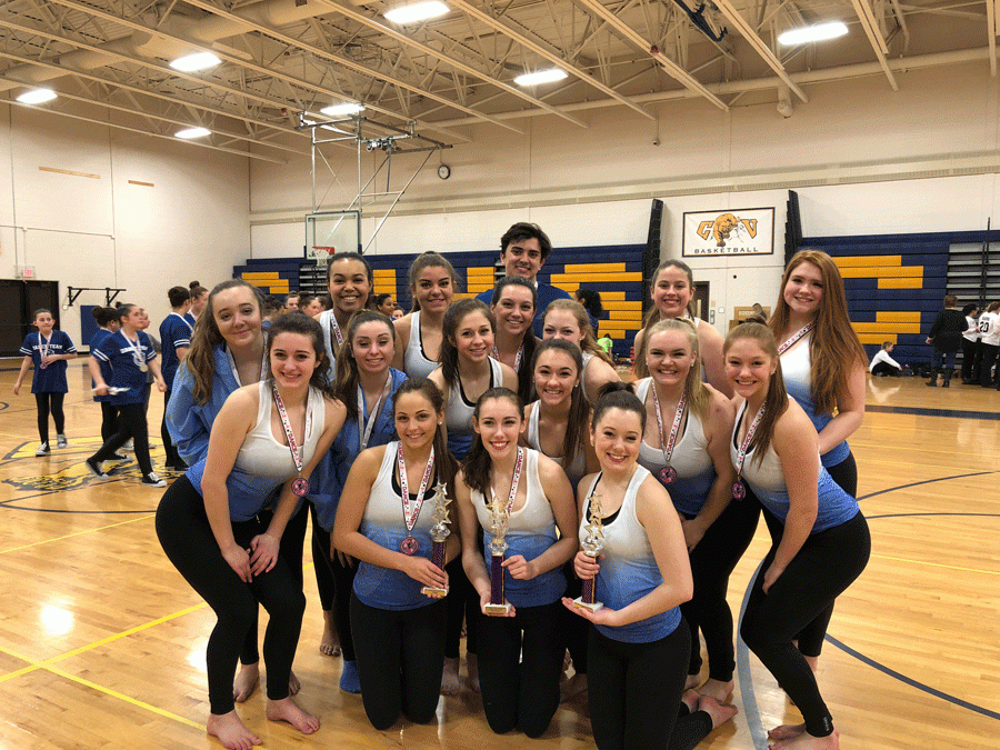 The dance team with their awards. 
