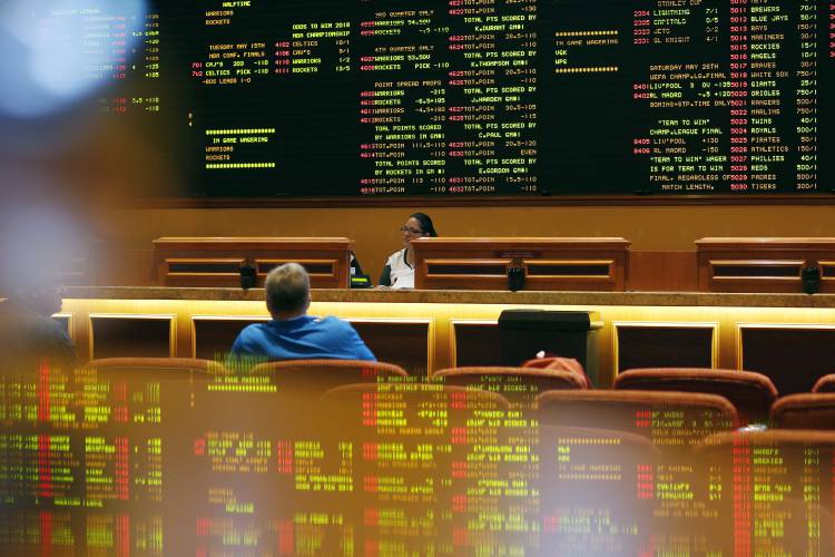 Betting odds are displayed on a board in the sports book at the South Point hotel and casino in Las Vegas.