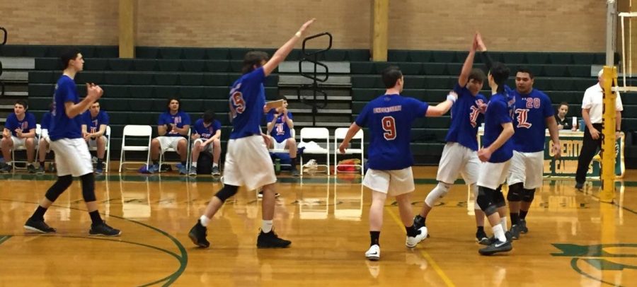 Agrella (right center) celebrates with his teammates after winning a point.