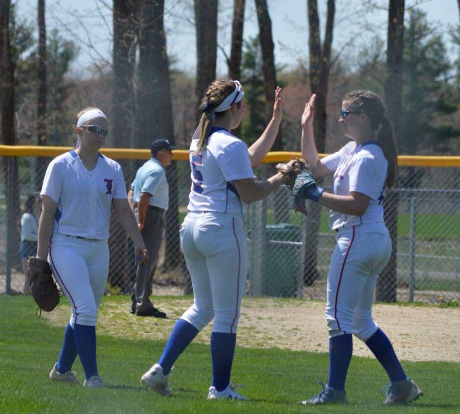  Junior Miranda Galan, Sophomore Gia Komst, and Senior Lauren Misiaszek celebrate in the outfield after a stellar play.