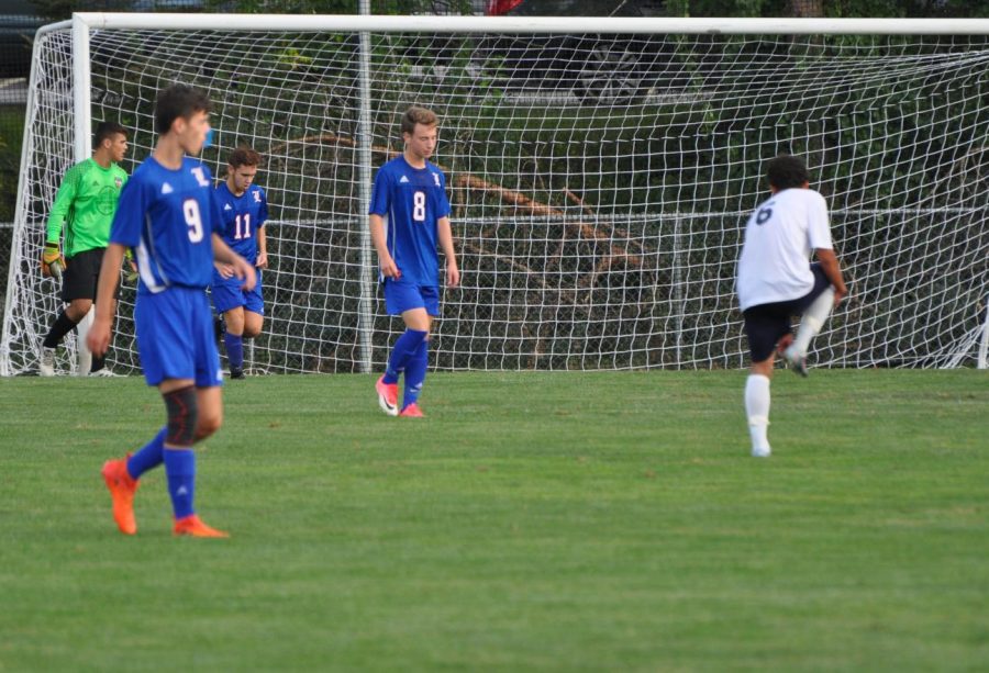 Brady Hanley (8) prepares for a free kick in front of his own goal.
