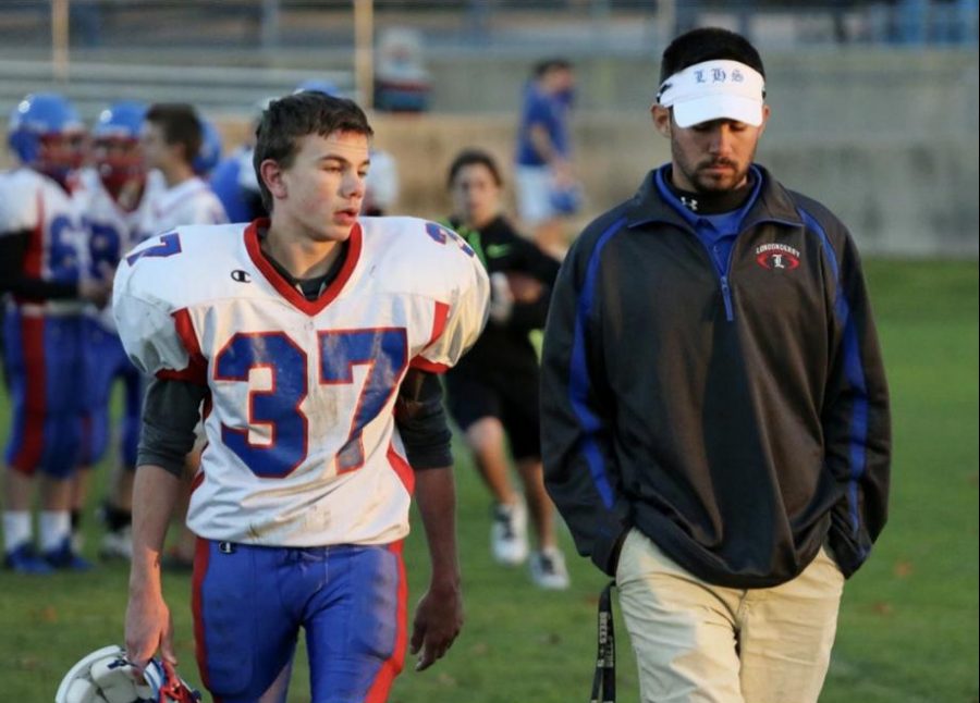 Coach Case sharing a word with former star Connor Dubois before game time.