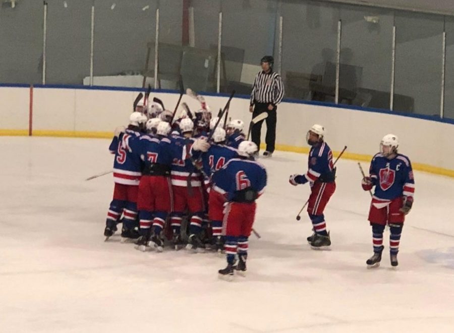 The Lancer squad celebrates in a team huddle after an exciting win.