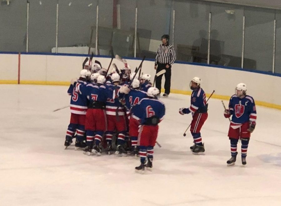 The Lancer squad celebrates in a team huddle after an exciting win.
