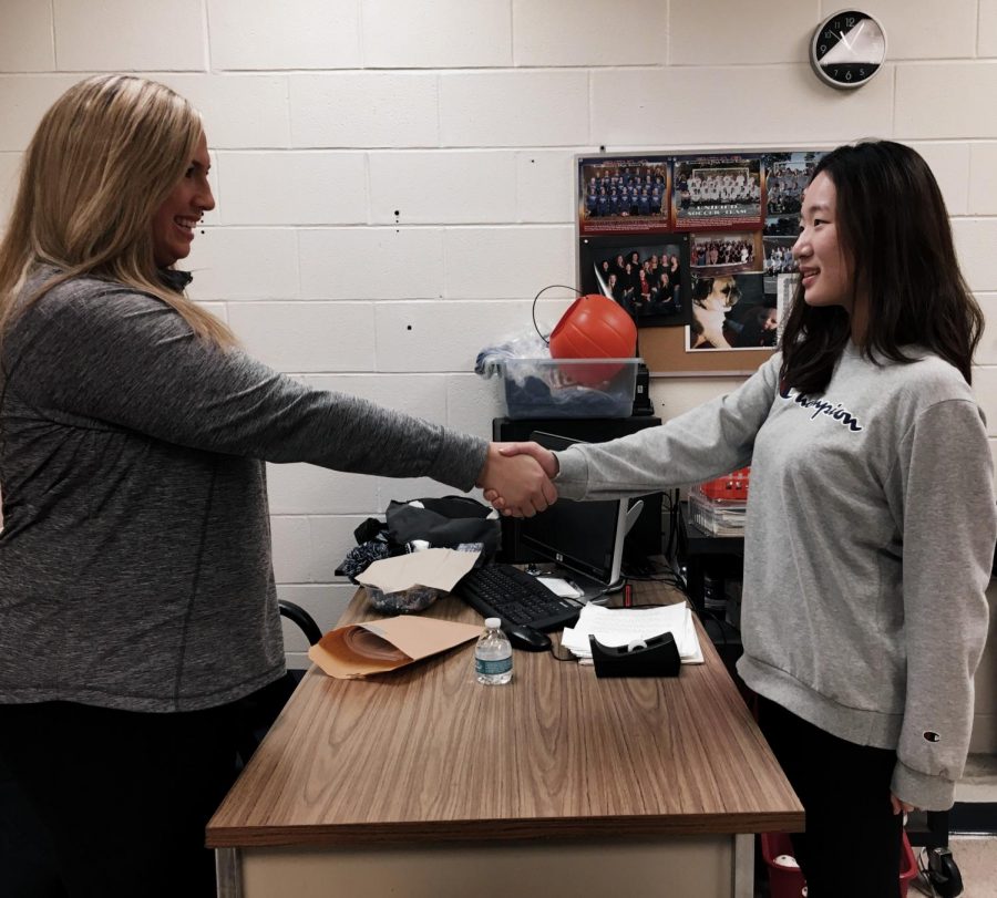 Mrs. Tebbetts (left) and Lauren Kim (right) shaking hands at the end of an interview.