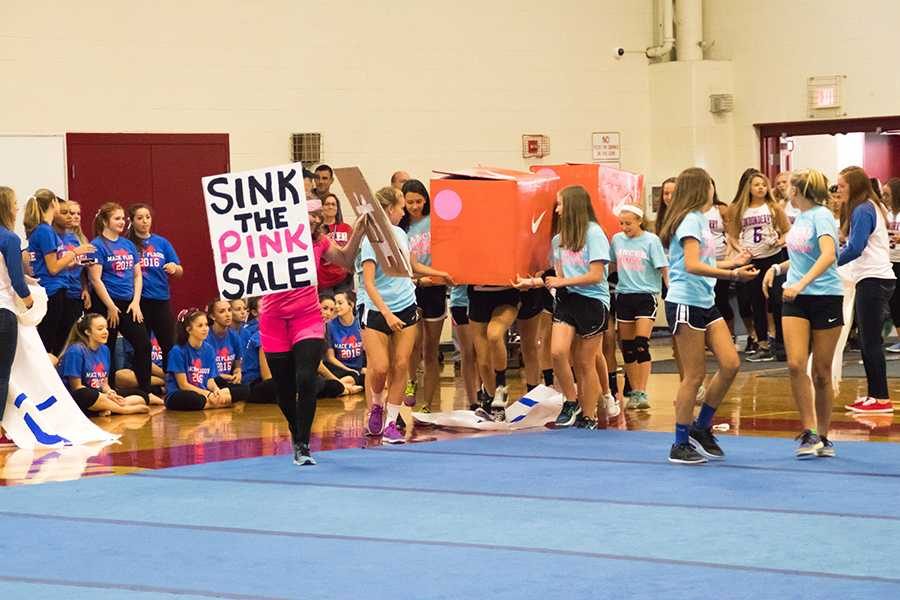 Girls cross country takes the floor in a creative skit at the Mack Plaque pep rally in the fall of 2016.