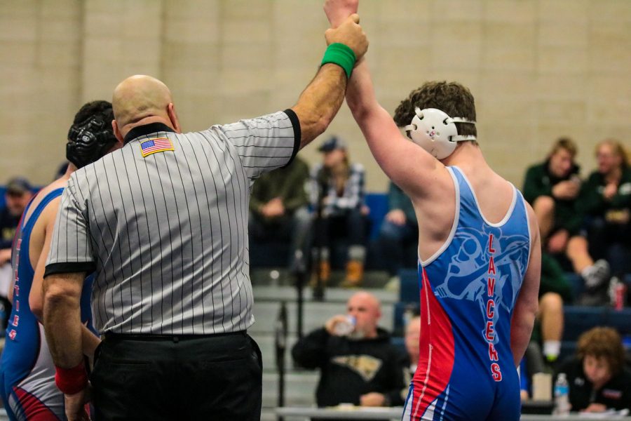 Jack Kelley raises his arm in triumph after winning a match in the the Merrimack Duals. He and the team trained for a month preparing for this meet.
