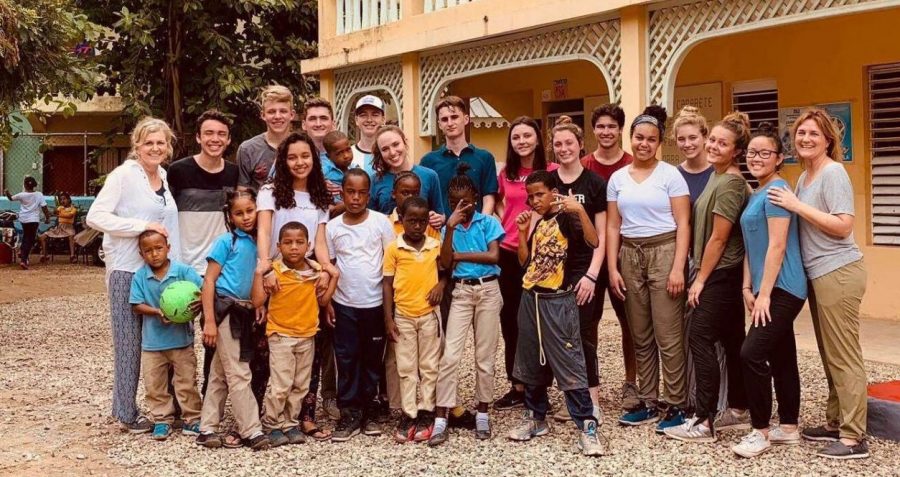 LHS students gather with local children from the Dominican Republic while on a mission trip during February break. 