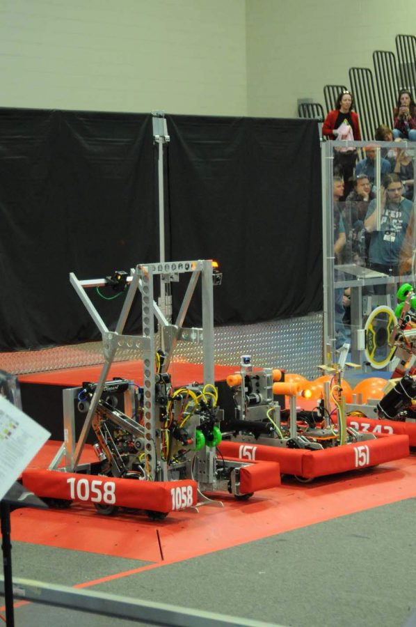 The LHS Robotics teams robot (number 1058) prepares for the match to start. Every match starts with the sandstorm period, where drivers are restricted from seeing the field by black drapes.