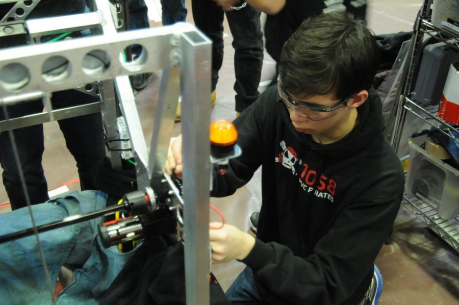 Sophomore Jon Mok works on the robot during a spare minute. Over a three day competition, many repairs and modifications must be made to the robots.