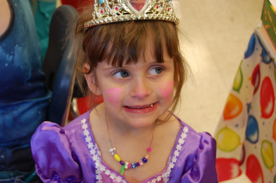 Brielle smiles after she gets dressed up like a princess. Brielle enjoyed when we went outside and played with a parachute.