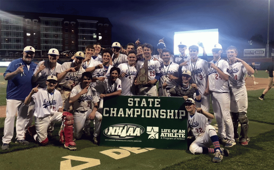 The LHS baseball team holds banner after winning the State Championship. 