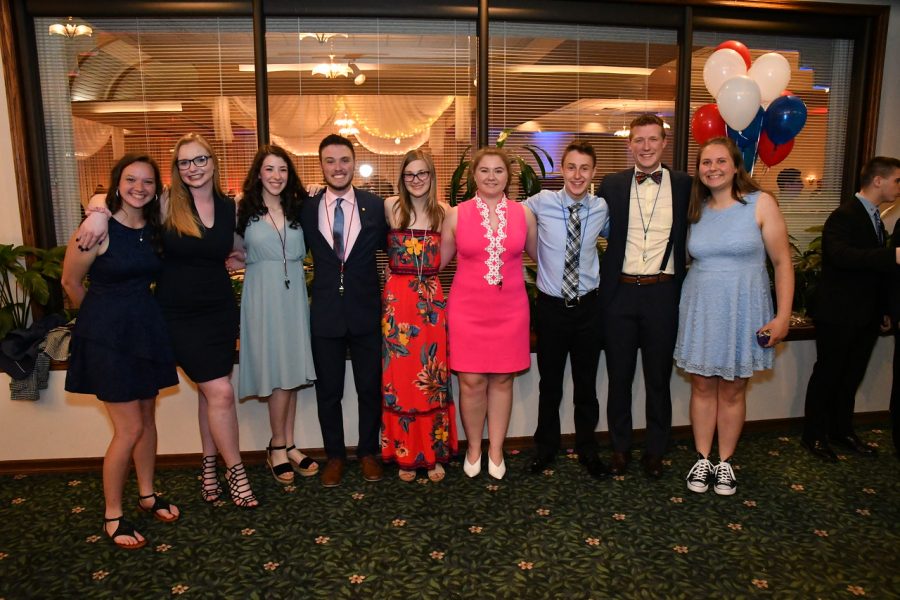  The new drum majors, colorguard captains and current drum majors pose for a photo after the highly anticipated announcement at the Lancer Music Banquet on May 30, 2019. 