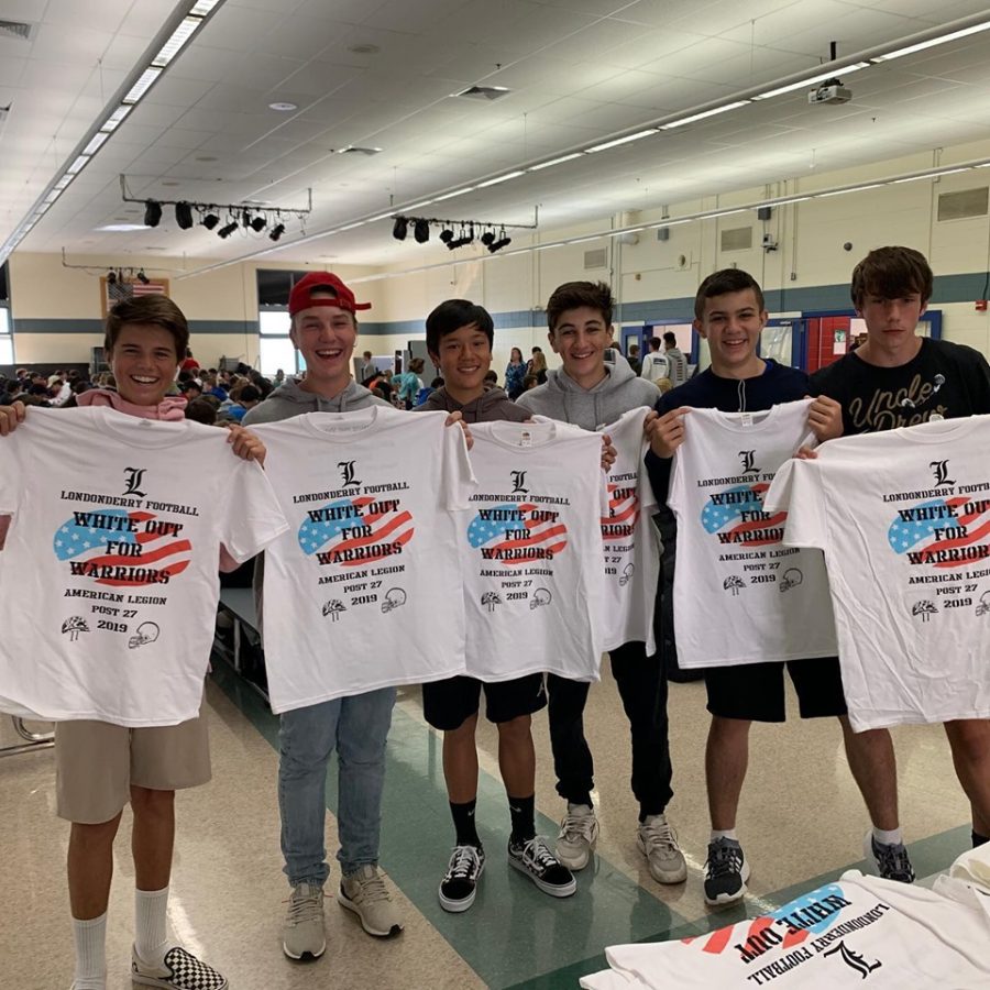 Students hold up recently bought t-shirts in support of the American Legion.