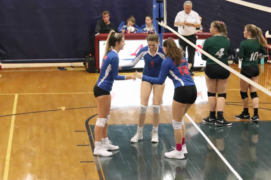 Junior Emma Detellis, sophomore Kelsey Sanborn, and junior Sarah Joe play front row and are ready to block some hits.