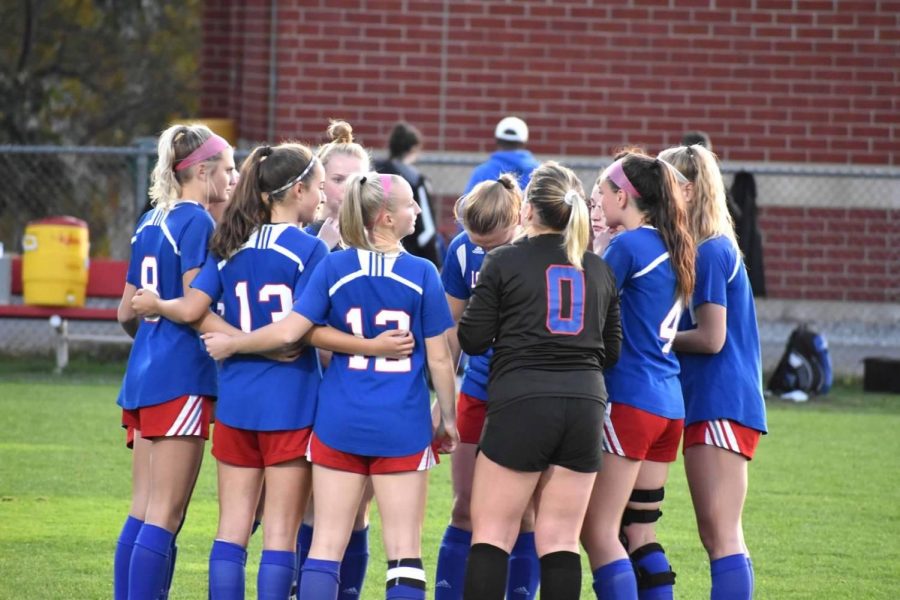 The girls varsity soccer team gather together to strategize their next play during the recent game against Exeter. 