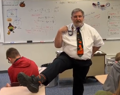 Mr. Tallo shows off his Halloween socks as he tells The Lancer Spirit what his favorite candy is.