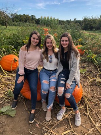 Senior Alex Kelly and LHS    alums Erin and Caroline Kelly enjoy a day of apple picking at Macks Apples.