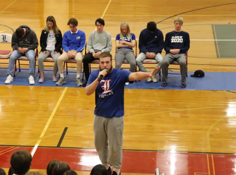 Senior Blaine Hopkins tells kids to stop laughing. He made them sit on the ground for 5 minutes. 